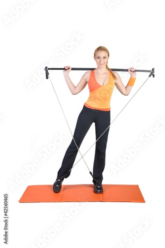 Fit young female pilates instructor showing different exercises