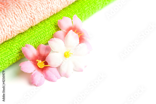 Stack of towels and flowers.