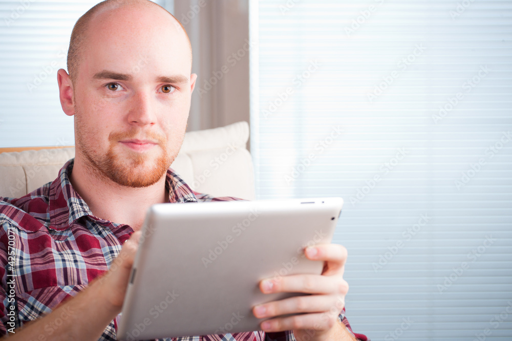 Focused man working and playing with tablet computer (lots of co Focused man working and playing with tablet computer (lots of co