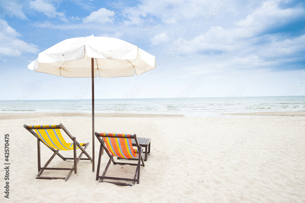 colorful beach chair on sandy beach and clear blue sky