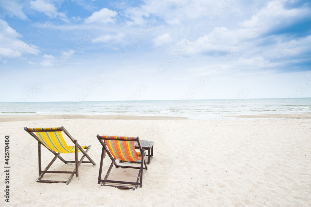 Beach chair on white sandy beach and clear sky