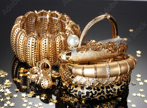 Beautiful golden jewelry on grey background