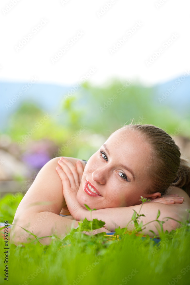 portrait of young beautiful positive woman lying and relaxing in portrait of young beautiful positive woman lying and relaxing in