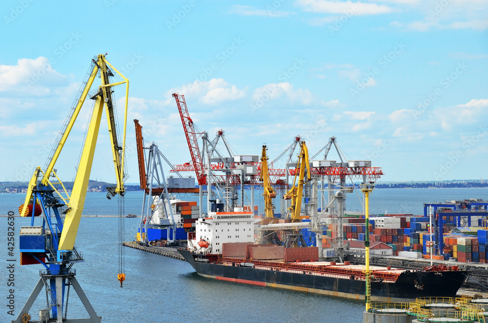 Container stack and ship under crane bridge