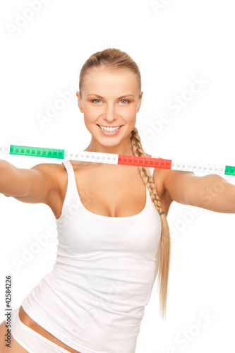 young beautiful woman with measure tape © Syda Productions