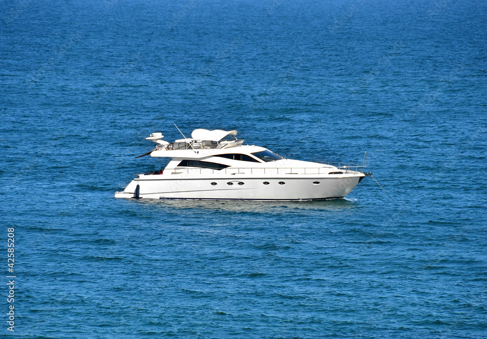 White motor yacht over blue sea background