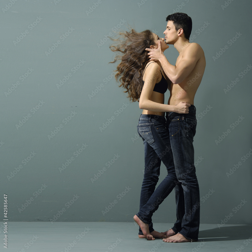 Sexy young couple wearing jeans in love Photos | Adobe Stock