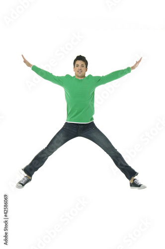 casual young man jumping on white