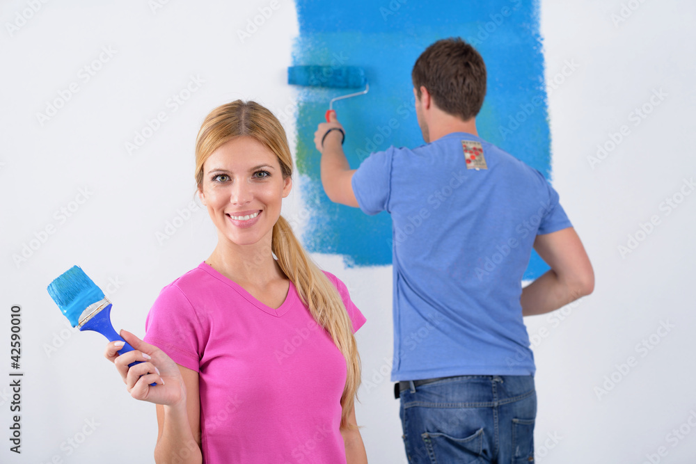 happy couple paint wall at new home happy couple paint wall at new home