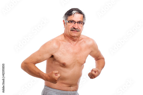 Senior man showing muscles