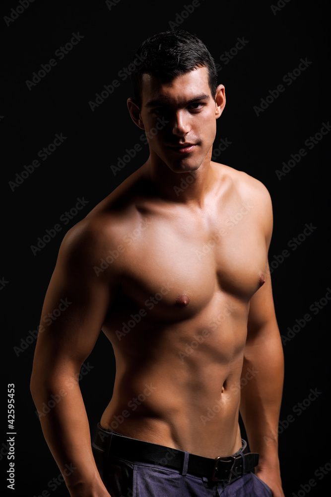 Healthy muscular young man. Isolated on black background. Healthy muscular young man. Isolated on black background.