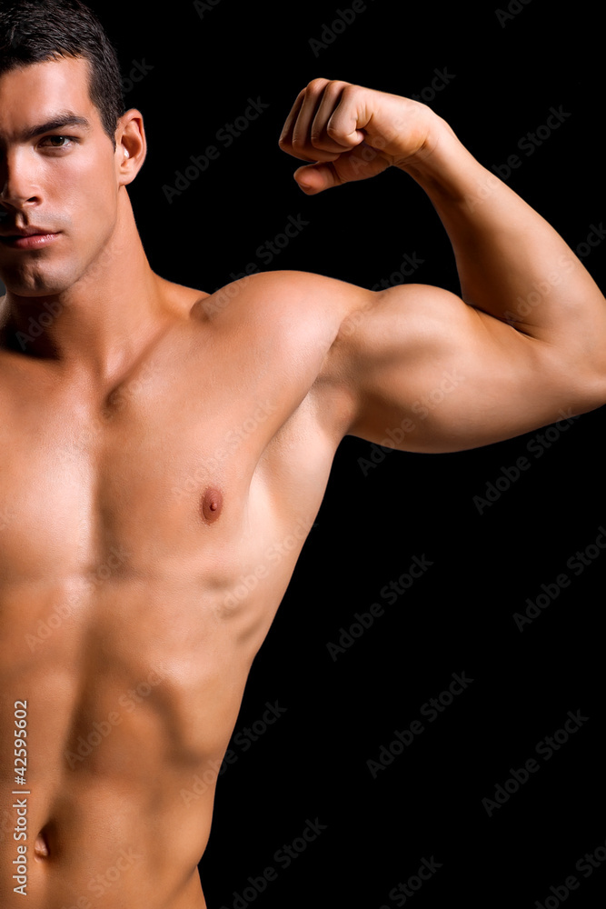 Healthy muscular young man. Isolated on black background.