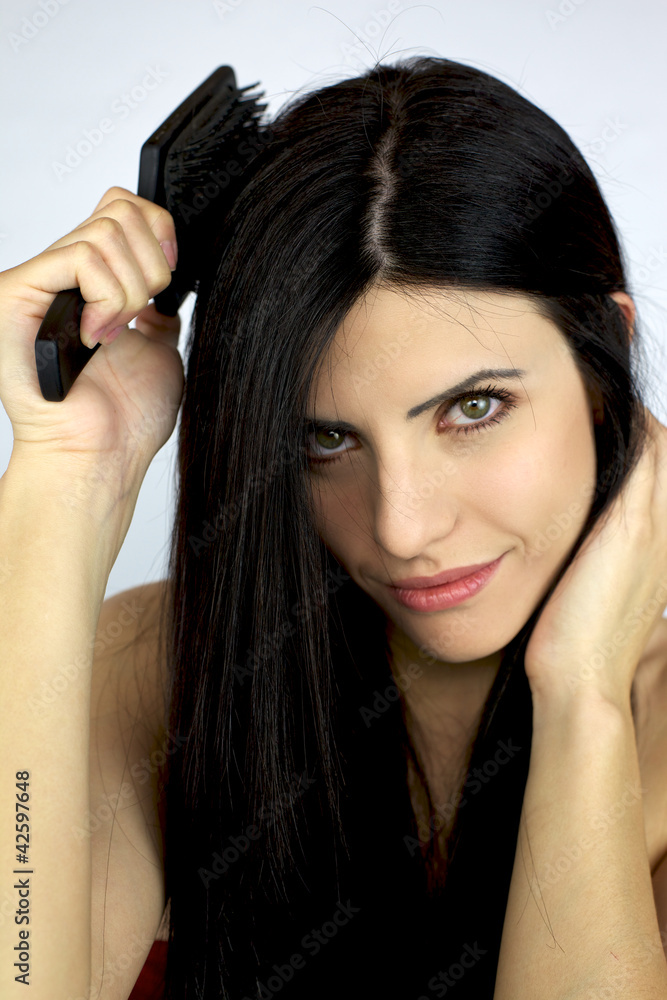 Fototapeta premium Beautiful girl brushing her long black hair