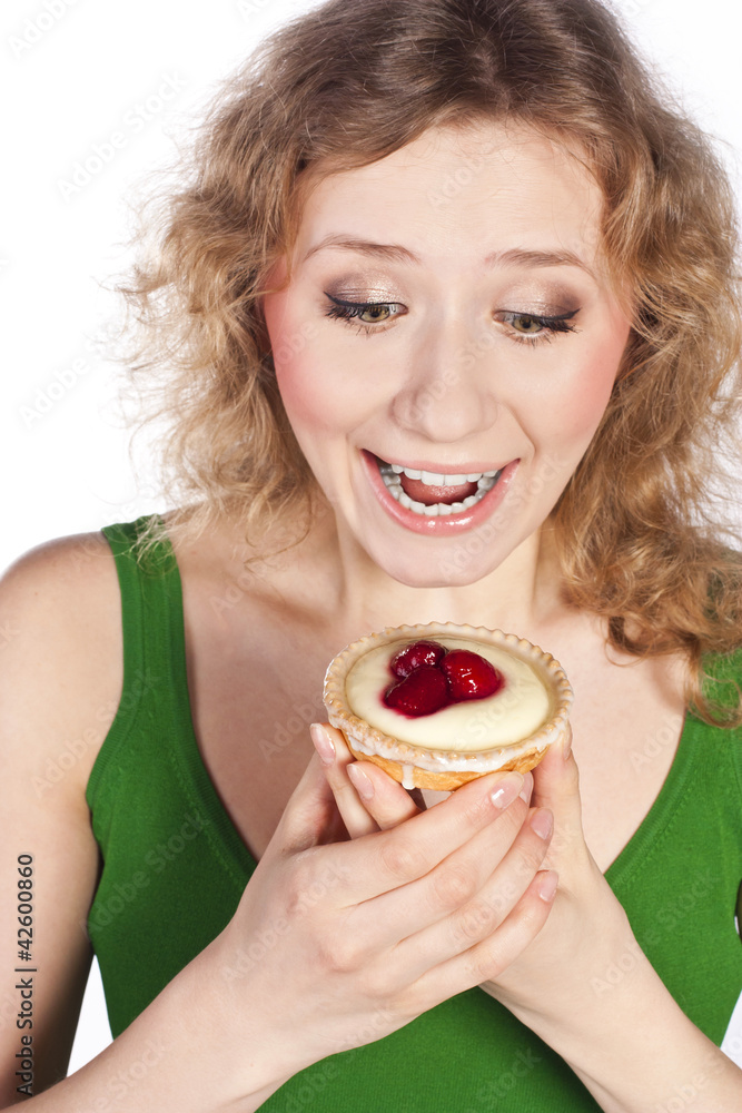 Woman eating a cake. In studio