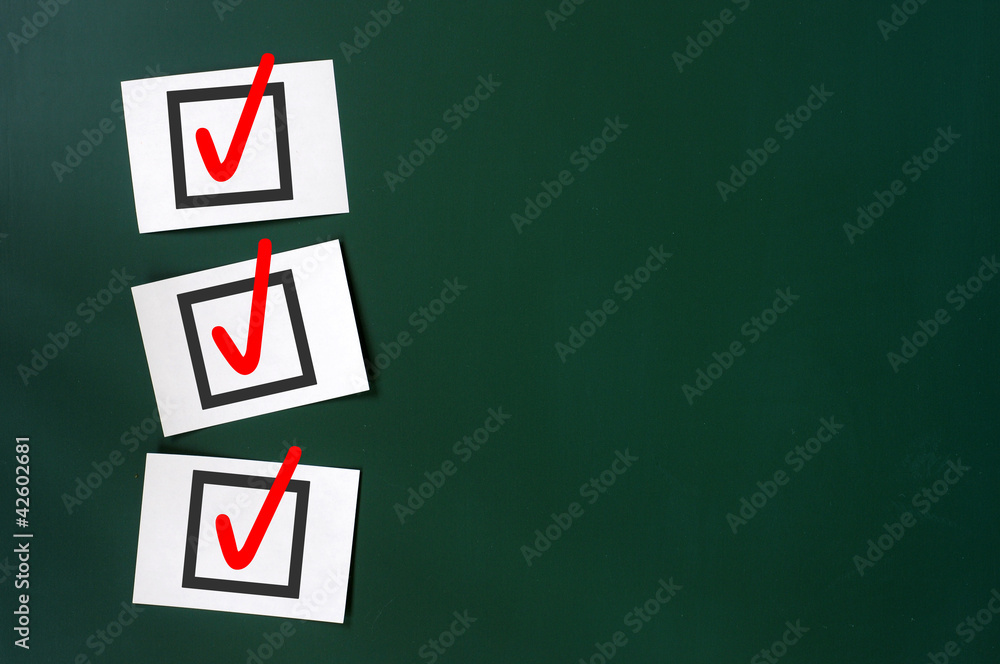 Check box with red tick on a green chalkboard Check box with red tick on a green chalkboard