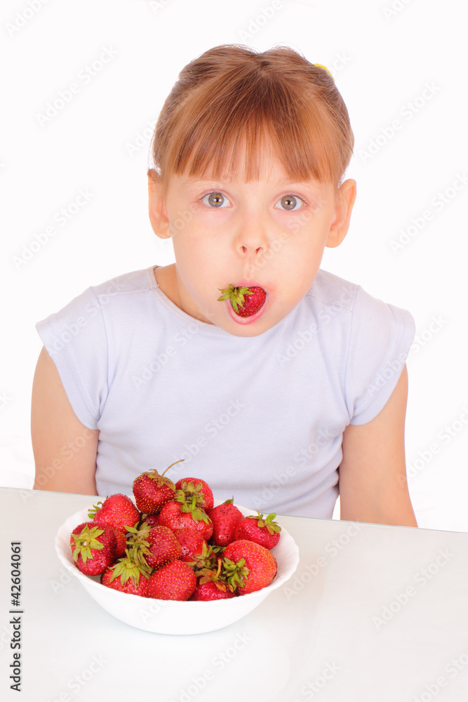Funny little girl eating strawberries Funny little girl eating strawberries