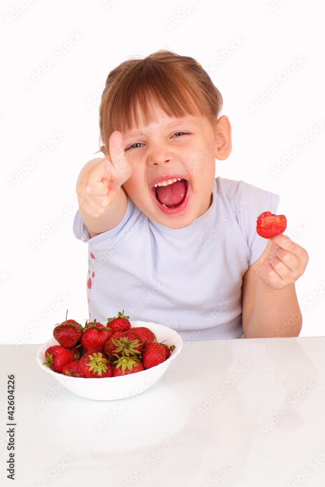 Funny little girl with a white soup plate with strawberries Funny little girl with a white soup plate with strawberries