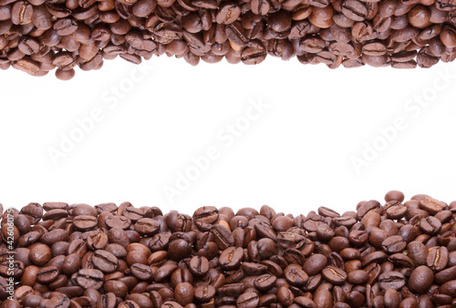 Two lines of roasted coffee beans