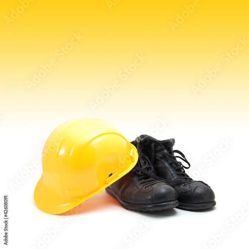 Yellow hard hat and old boots