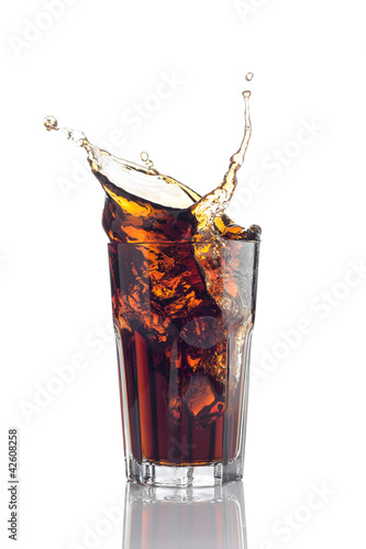 Bild auf Leinwand splash in glass of cola with ice cubes