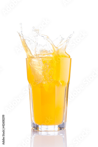 splash in glass of orange soda with ice cubes