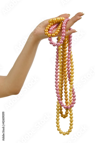 Pearl necklace in hand on white
