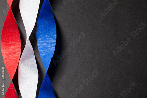 Red white and blue crepe paper on black background