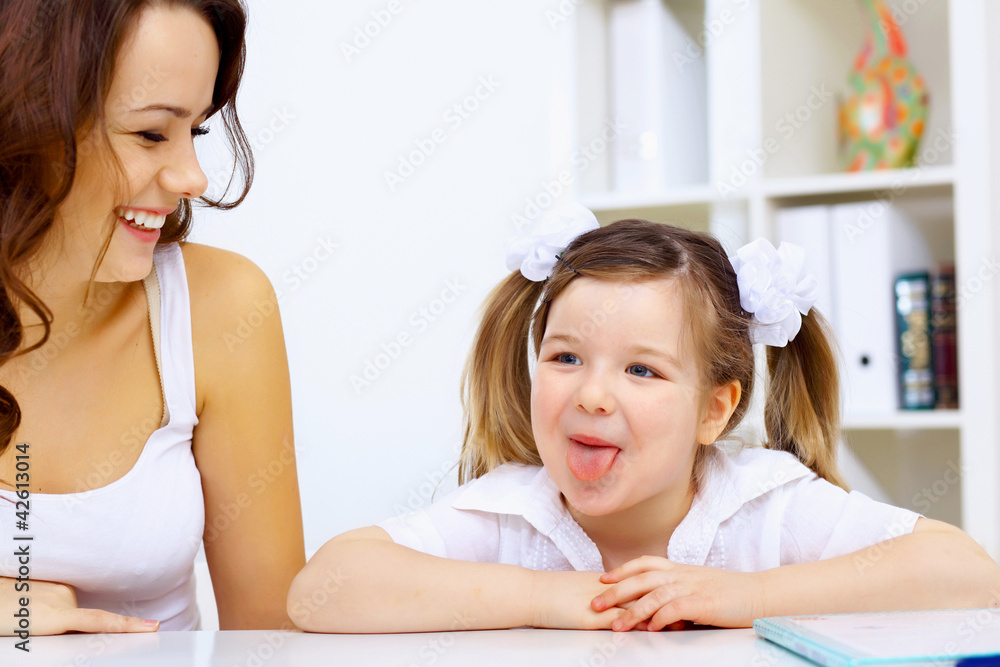 Little girl and her mother studying Little girl and her mother studying
