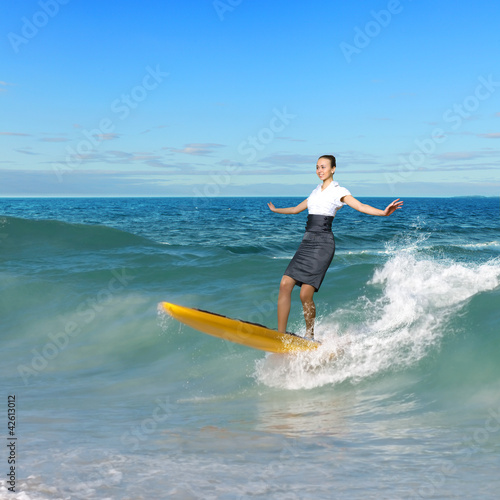Photography Young business person surfing on the waves