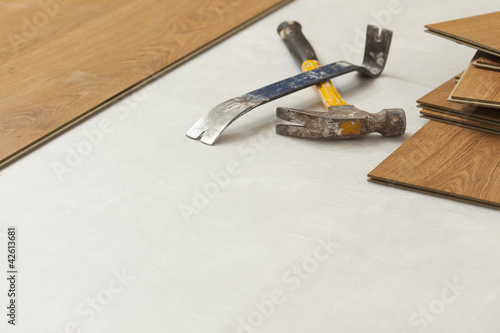 Hammer and Pry Bar with Laminate Flooring Abstract photo