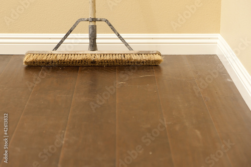 Push Broom on a Newly Installed Laminate Floor and Baseboard photo