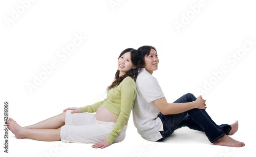 Pregnant woman and husband sitting on the floor