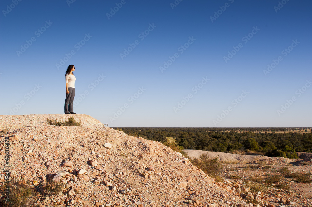Woman in outback landscape around Lightning Ridge in rural Australia