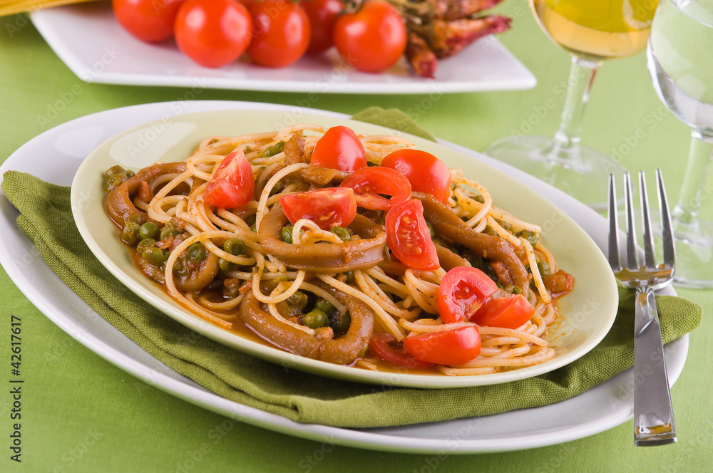 Spaghetti with squids, peas and cherry tomatoes. Spaghetti with squids, peas and cherry tomatoes.