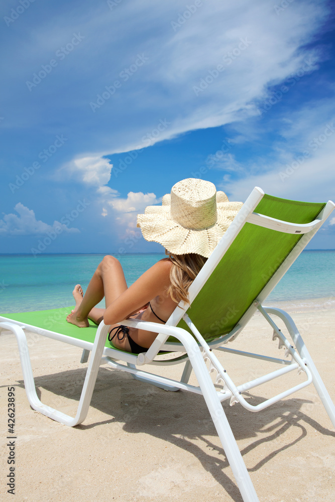 Woman relaxing on a beach Woman relaxing on a beach