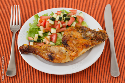 grilled chicken with vegetable salad on the plate