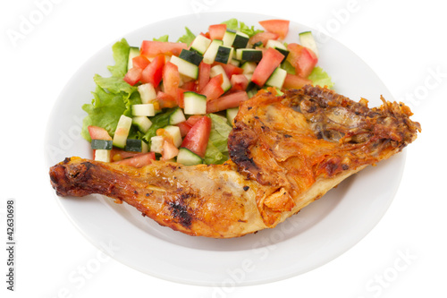 grilled chicken with vegetable salad on the plate