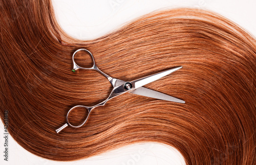 straight healthy woman hair and scissors