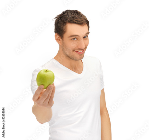 man in white shirt with green apple