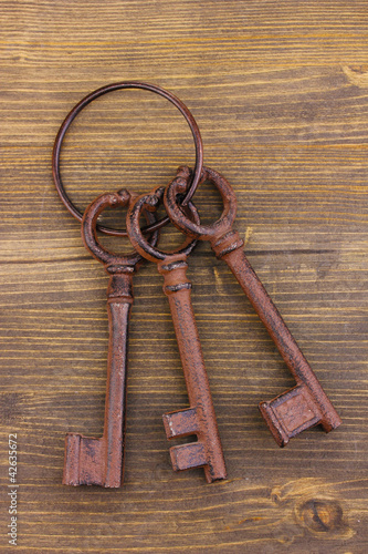 a bunch of antique keys on wooden background © Africa Studio