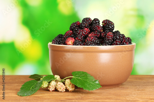 Ceramical bowl with ripe mulberries photo