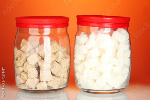 Jars with brown cane sugar lump and white lump sugar