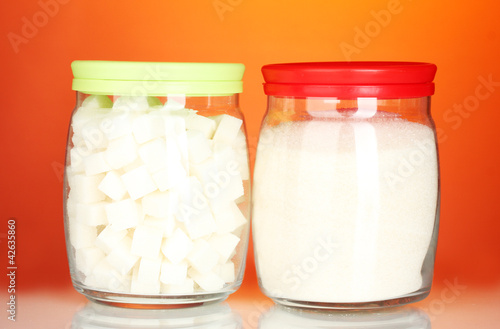 Jars with white lump sugar and white crystal sugar