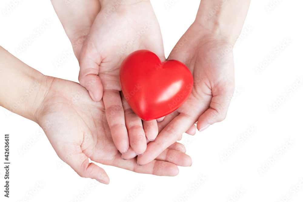 two pairs of hands carefully holding red heart two pairs of hands carefully holding red heart