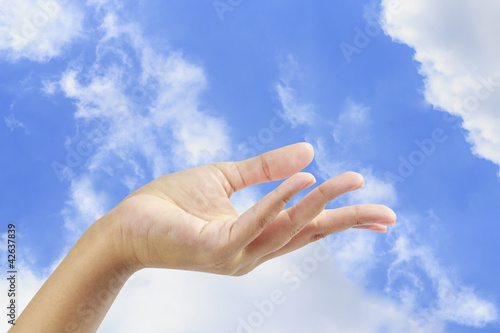 Empty hand palm on blue sky.