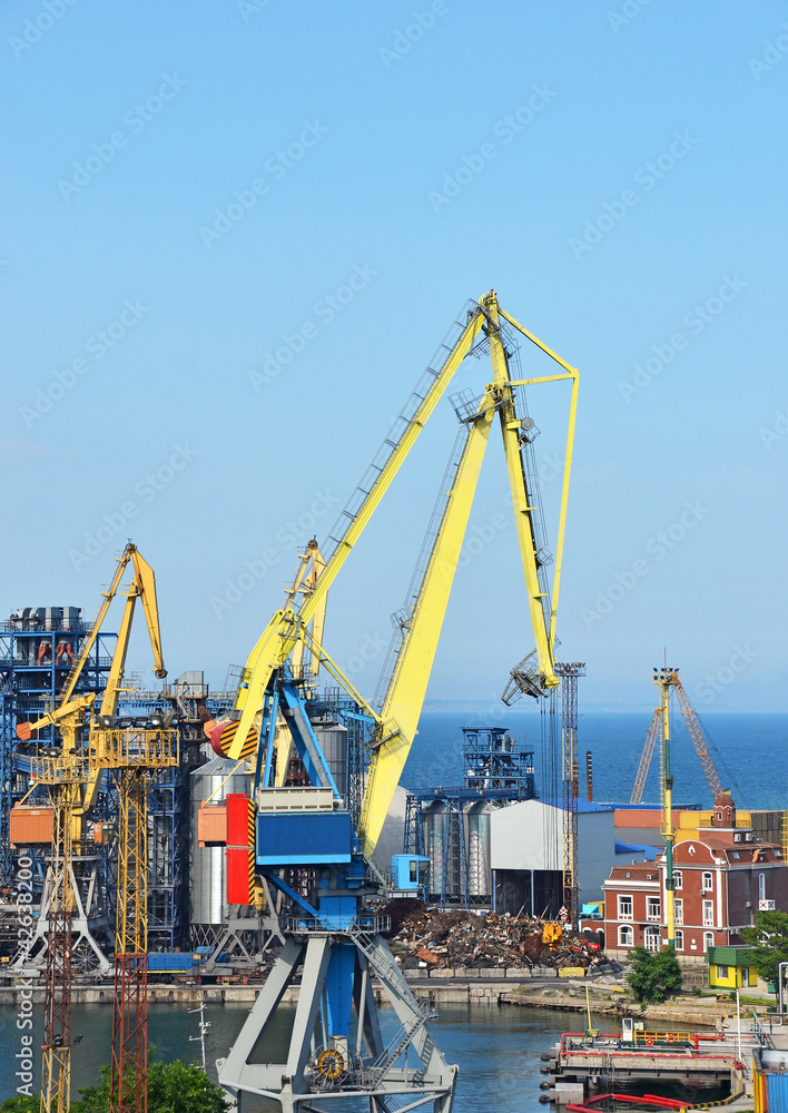 Port cargo crane over blue sky background