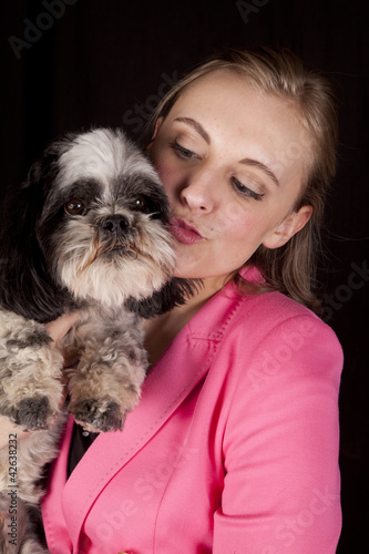woman pink jacket kiss dog
