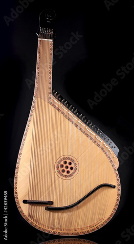 Retro bandura- Ukrainian musical instrument on black background