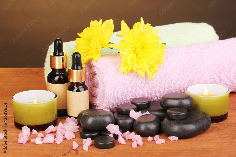 Spa setting on wooden table on brown background Spa setting on wooden table on brown background