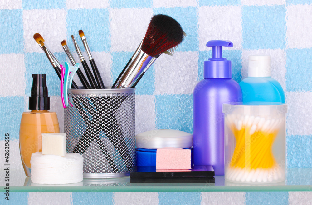 Shelf with cosmetics and toiletries in bathroom Shelf with cosmetics and toiletries in bathroom
